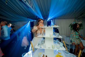 Wedding reception space bathed in blue lighting with elevated display platforms.
