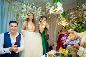 Elegant wedding reception venue decorated with hanging lights and floral arrangements creating a romantic atmosphere.