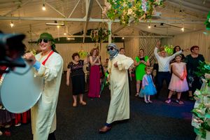 Wedding celebration features dynamic dancing and entertainment in a decorated indoor venue.