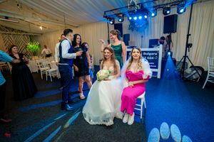 Indoor wedding reception with dramatic blue lighting and guests on the dance floor.