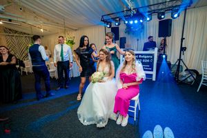 Wedding celebration in progress with blue mood lighting and dancing guests.