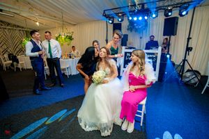 Wedding reception dance floor with blue lighting and guests celebrating.