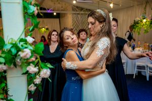 Wedding reception featuring elegant decor with green vines and white floral arrangements.