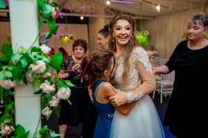 Joyful celebration moment captured during wedding reception with floral decor.
