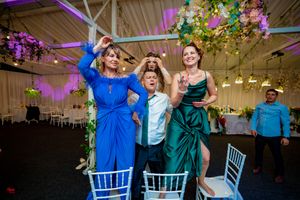 Wedding party members in blue and green attire celebrating at reception.
