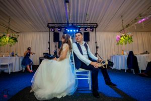 Indoor wedding celebration with dramatic lighting and dance floor entertainment.