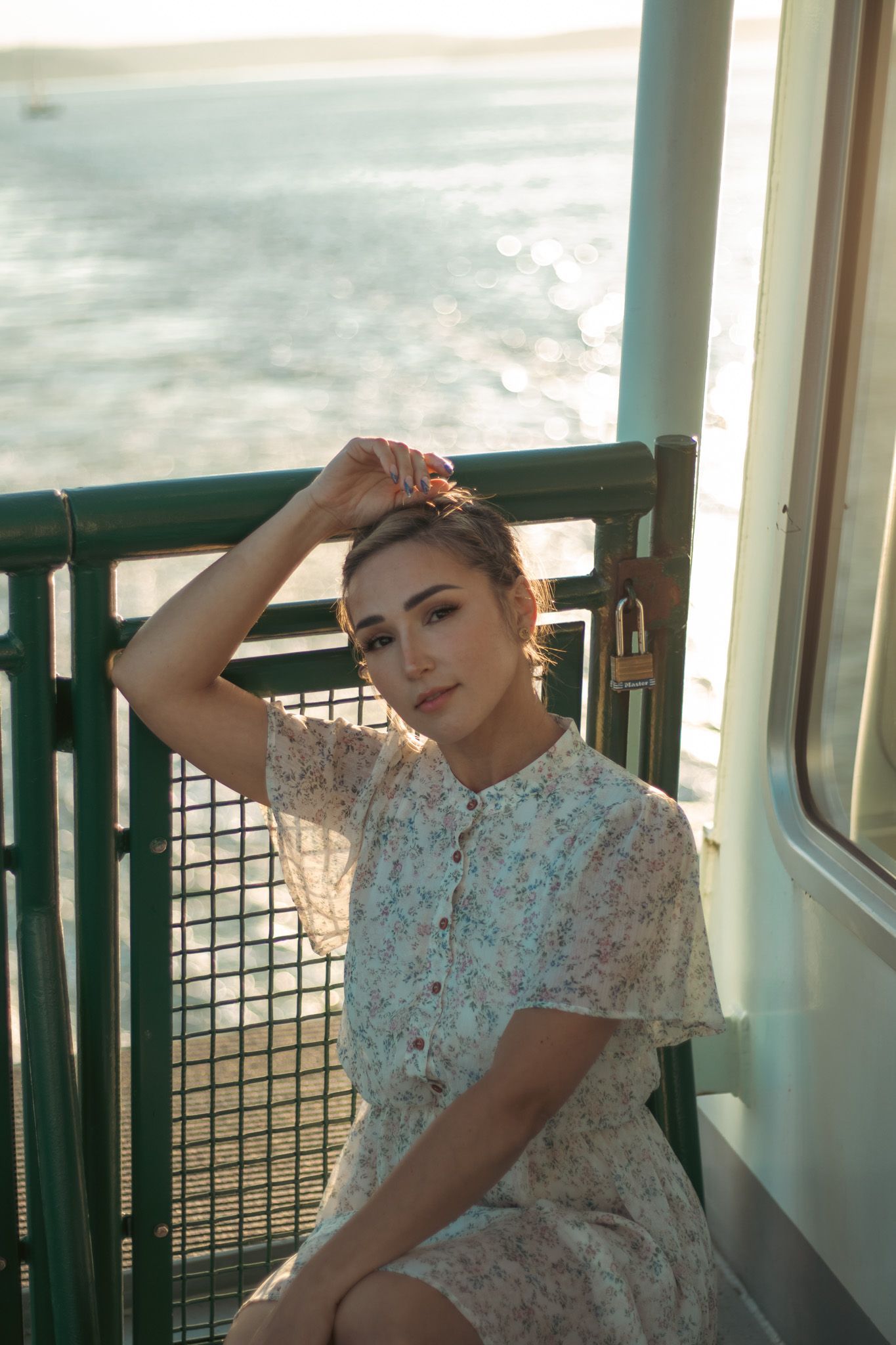 Sunlit portrait on boat deck wearing vintage style lace dress.