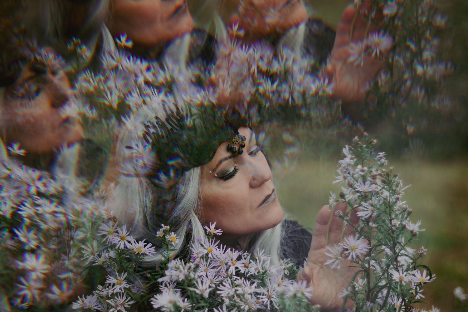 Dreamy multiple exposure portrait surrounded by delicate white flowers.