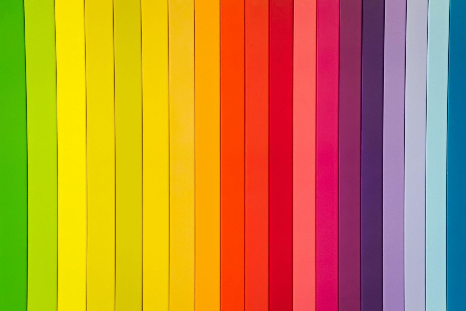 Vibrant vertical stripes arranged in a rainbow spectrum pattern creating a colorful gradient background.