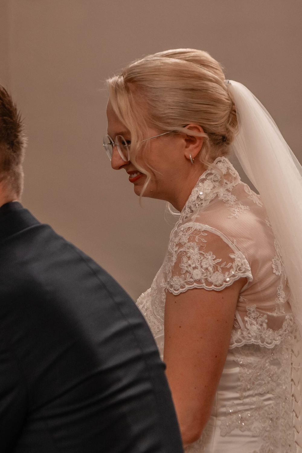 Close-up views of an elegant lace wedding dress detail showing delicate embroidery and beadwork patterns.
