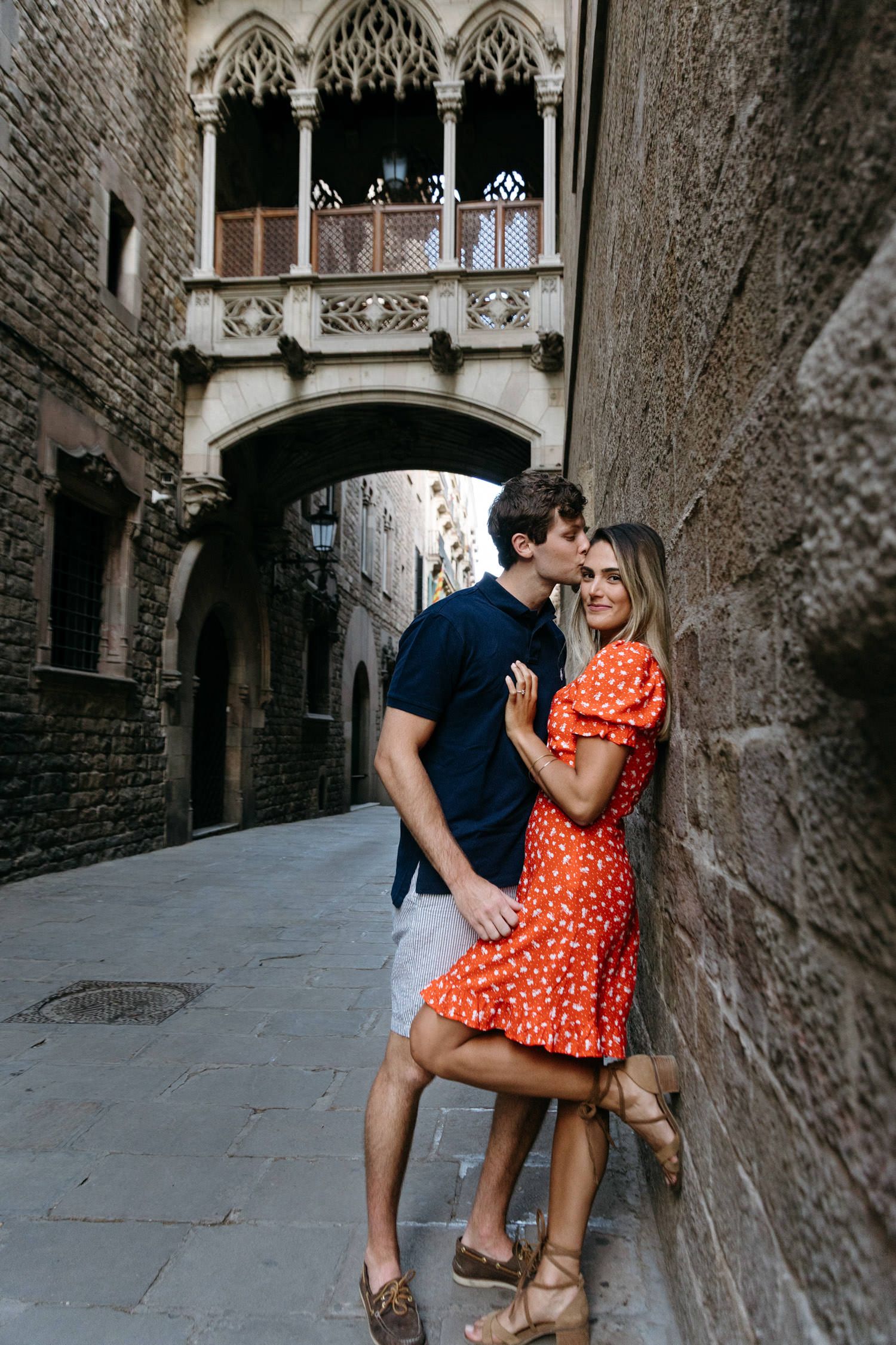 Romantic photoshoot in Gothic stone alleyway with arched architecture.