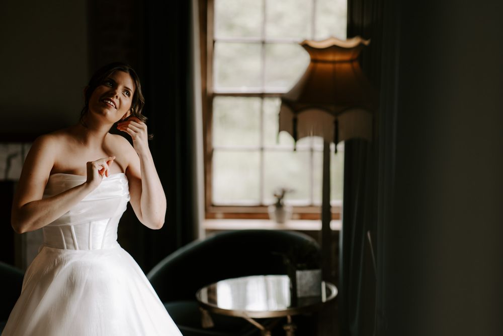 A series of candid bridal portraits in a moody, minimalist interior space with dramatic lighting.