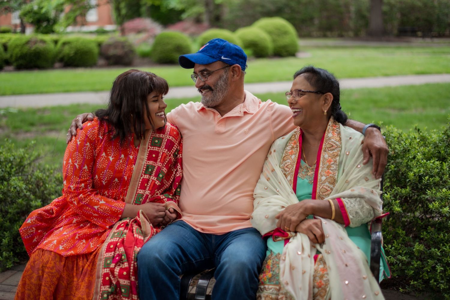 Parents and daughter smiling at each other