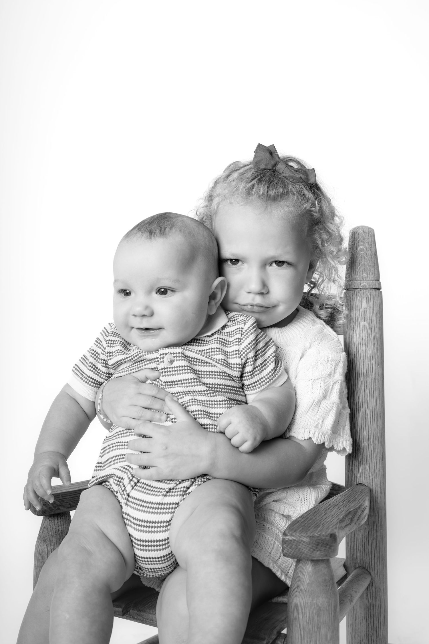 Children in denim overalls standing together in black and white studio shot Chattanooga Lifestyle Photographer