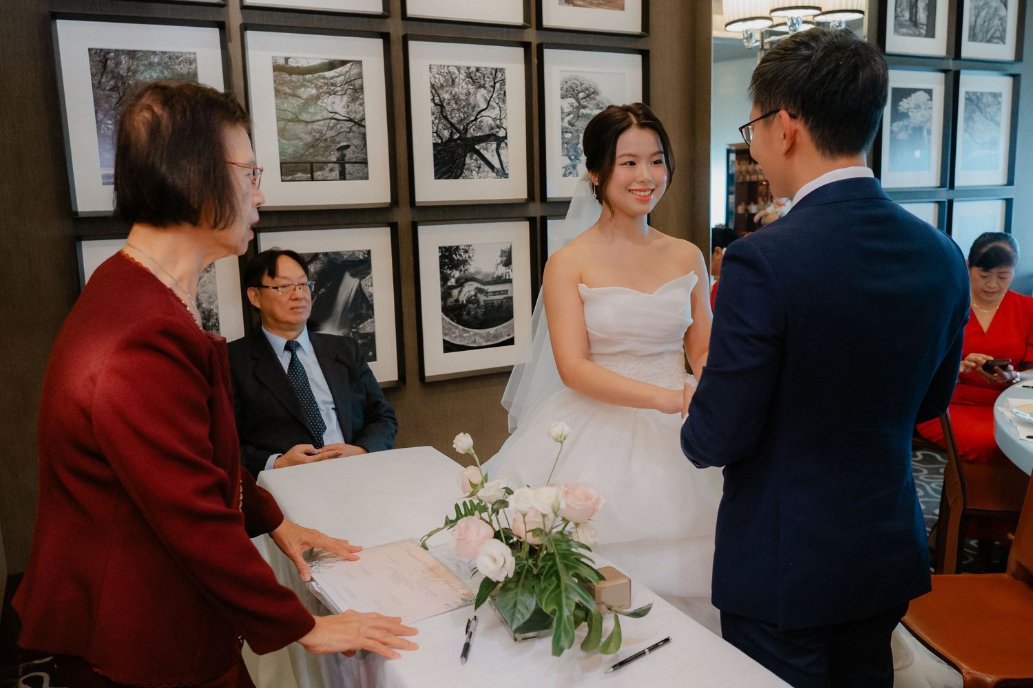 Wedding reception space with black and white framed photographs lining the walls.