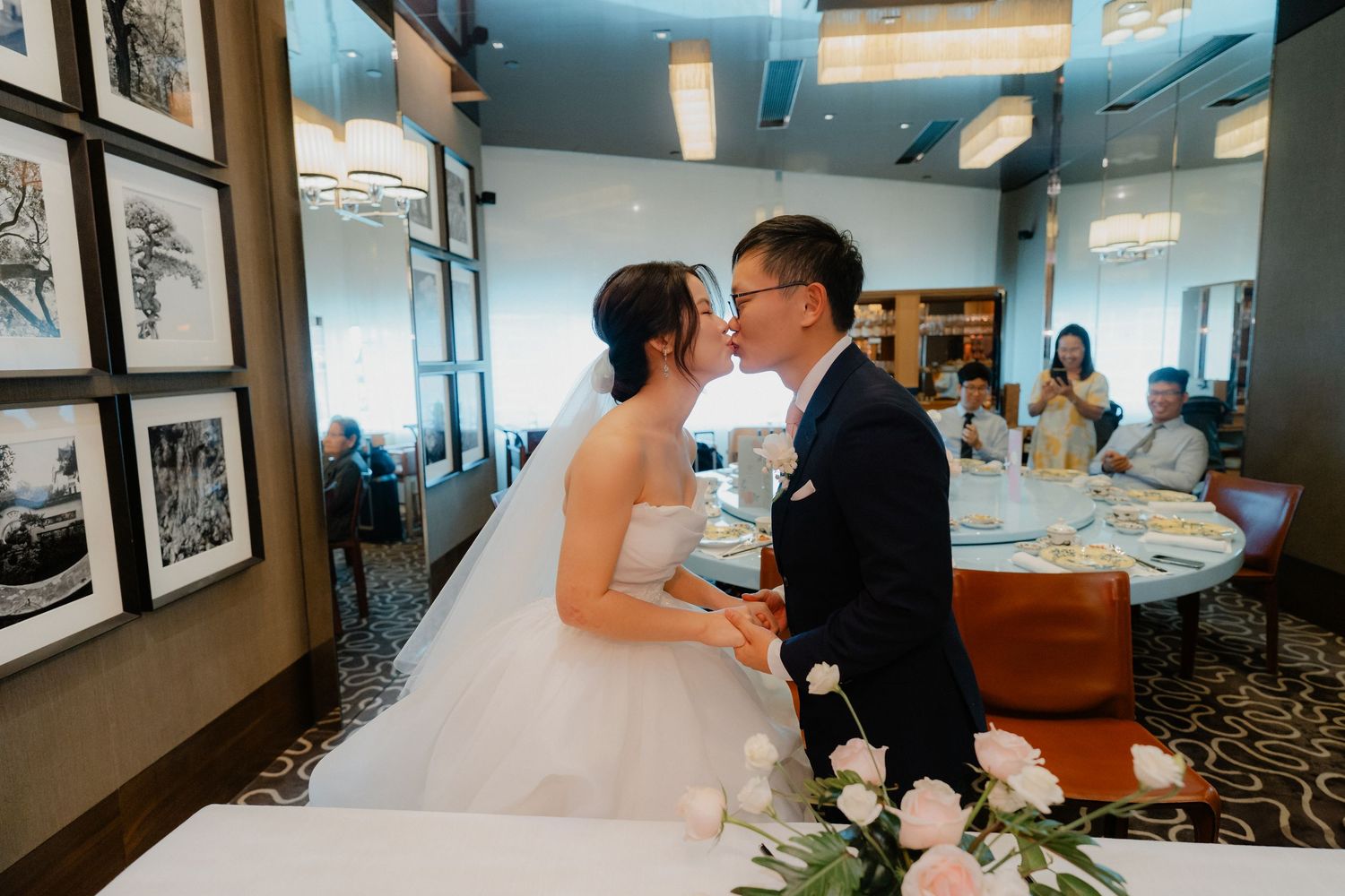 Wedding reception moment in a room decorated with vintage photographs.