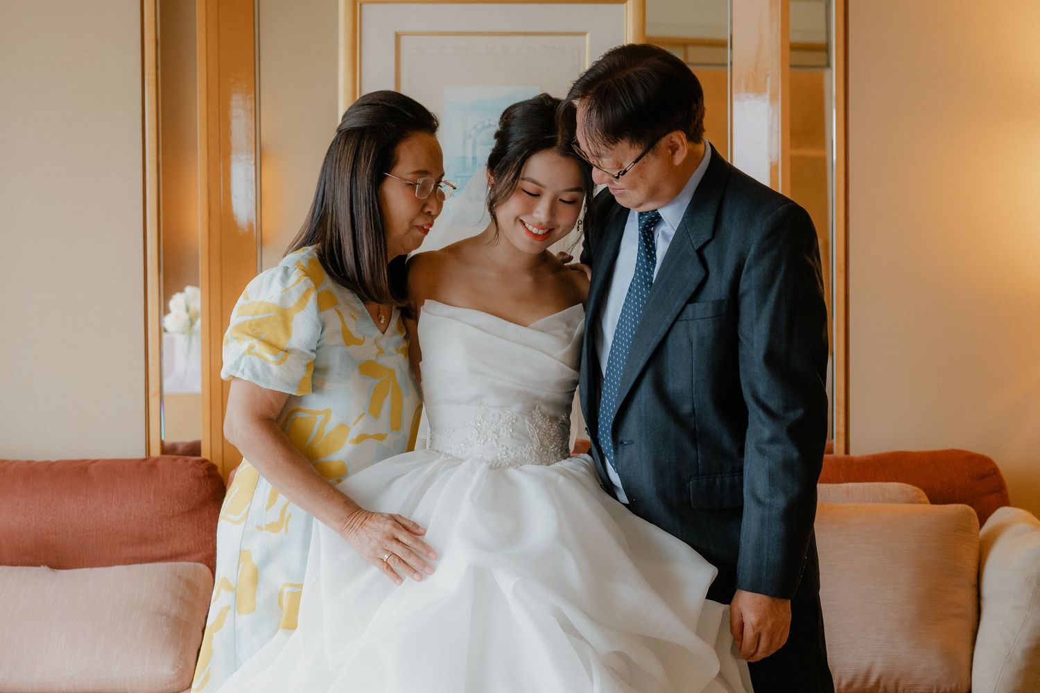 Intimate wedding moment captured in a hotel room with warm lighting.