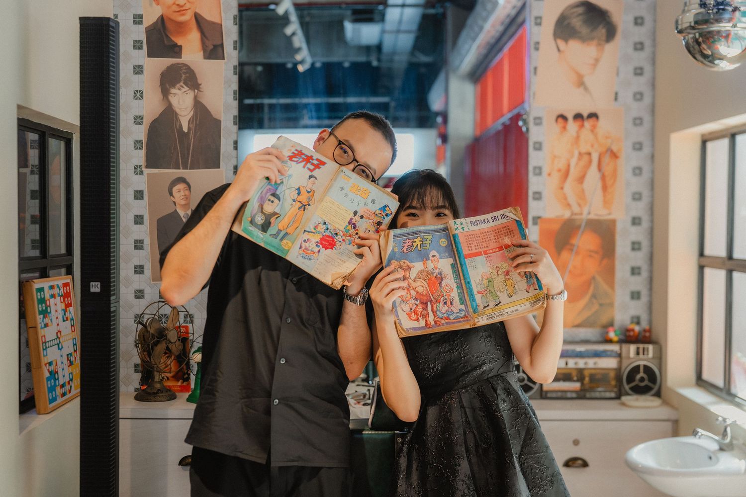 At a barbershop, someone gets their hair styled while posters and decorative items line the walls around them.