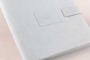 Close-up view of pristine white product boxes arranged in a minimalist style against a soft beige background.