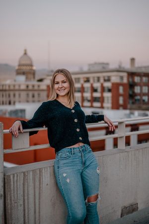 Sequence of outdoor rooftop portraits showing progressive movement against urban backdrop with brick buildings and cloudy sky.
