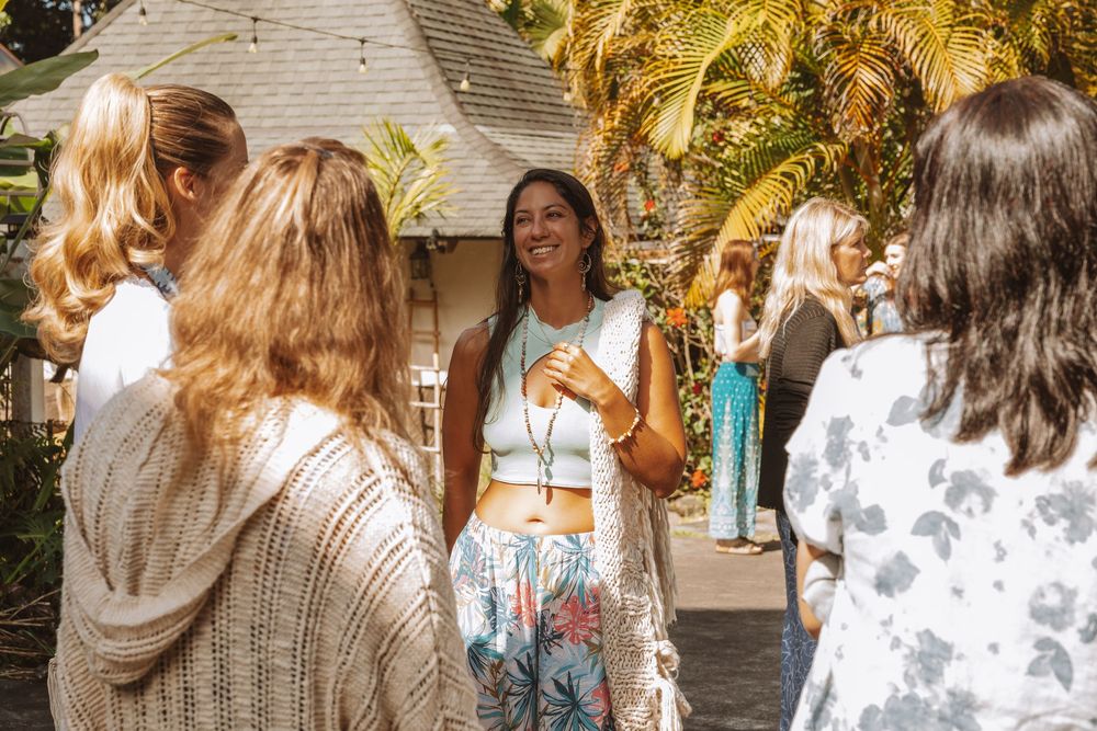 Outdoor gathering on stone pathway with warm lighting and natural decor.