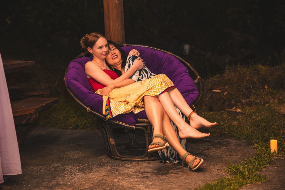 Cozy outdoor evening scene with purple papasan chair and ambient lighting.
