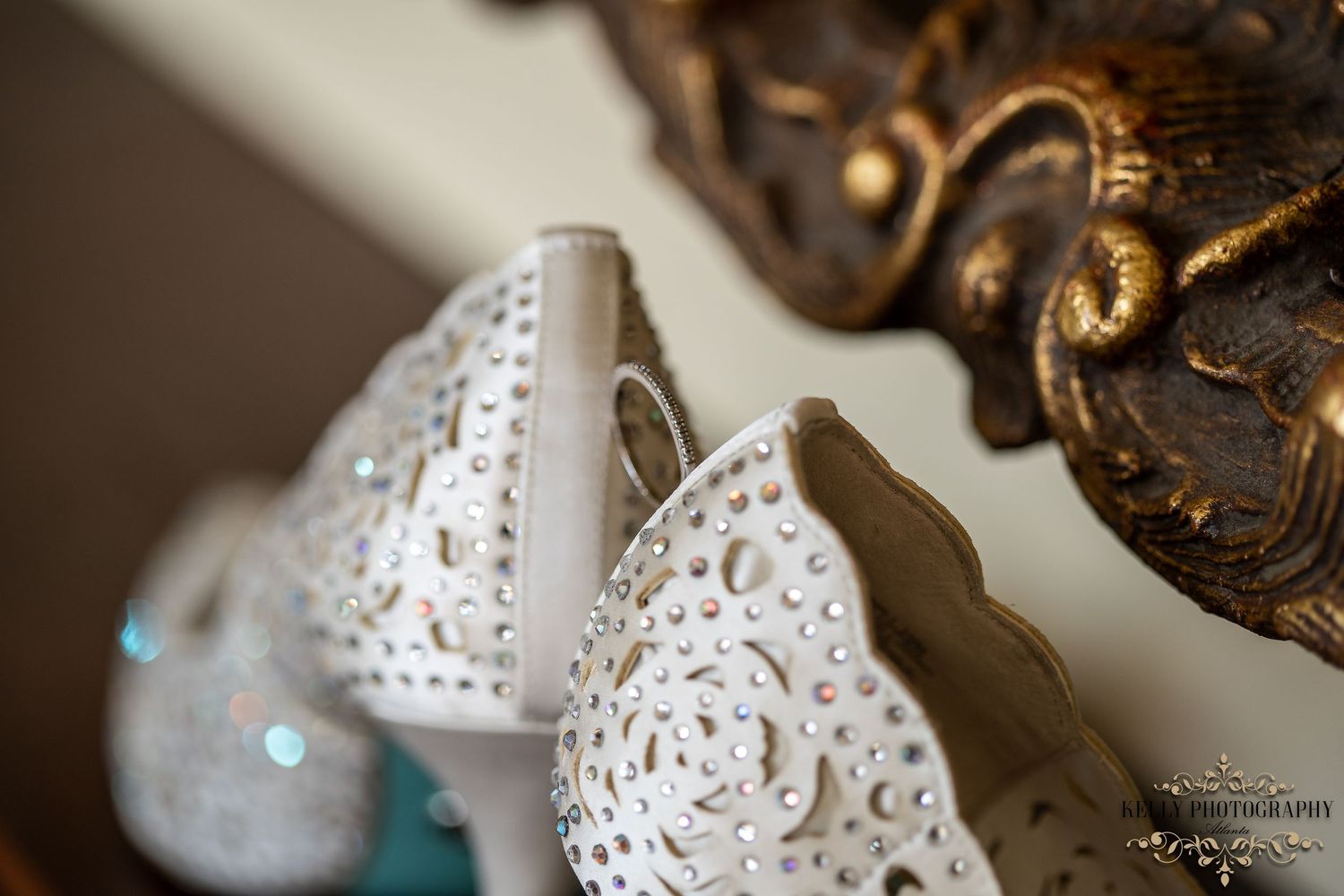 Close-up detail of intricate lace pattern on white bridal shoes.