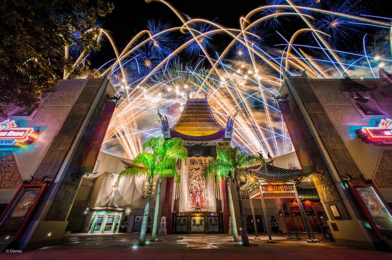 Colorful beams of light and architectural elements at Disney Hollywood Studios during nighttime.