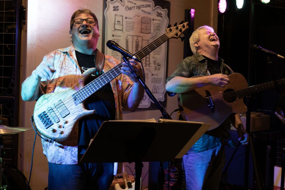 Man playing guitar and smiling
