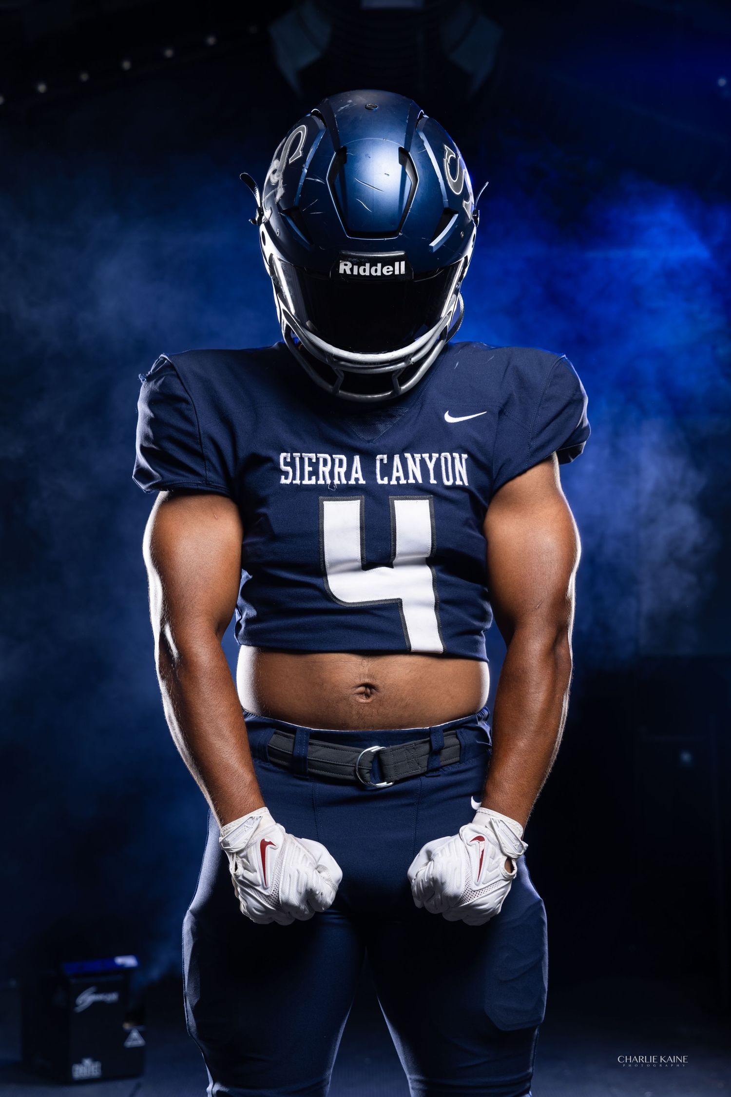 Football player in Sierra Canyon uniform number 4 poses against dramatic blue smoke background.
