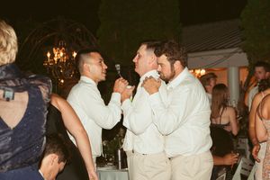 A group of partygoers enjoying a lively dance celebration with upbeat energy and festive lighting at a nighttime event.