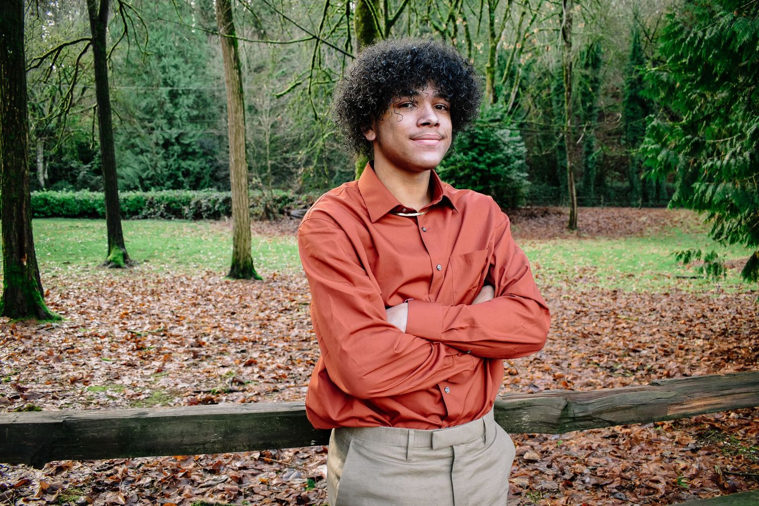 Fall senior portraits in Lake Fenwick Park, Kent, WA. Warm tones, fallen leaves, and a confident rust-colored outfit complete the look.