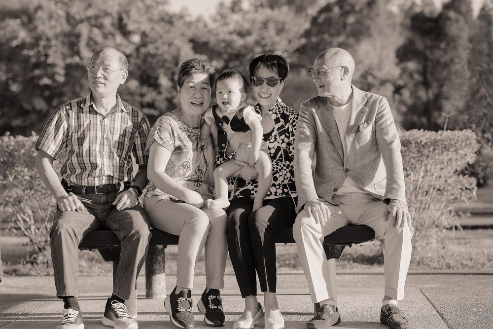 A series of black and white photos showing people sitting together outdoors on a sunny day.