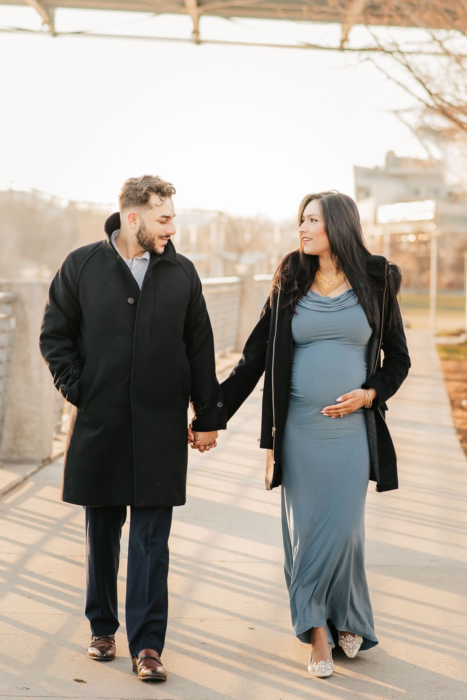 Expecting couple walking together through downtown Cincinnati during a winter maternity session