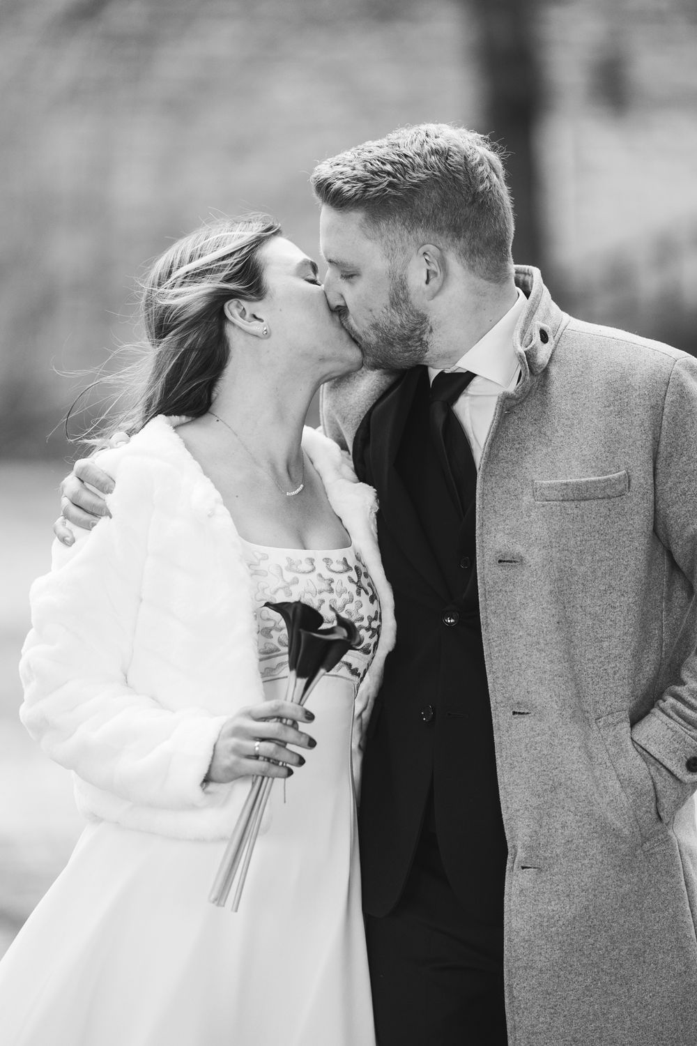 A romantic black and white photo series showing tender moments between a bride and groom on their wedding day.