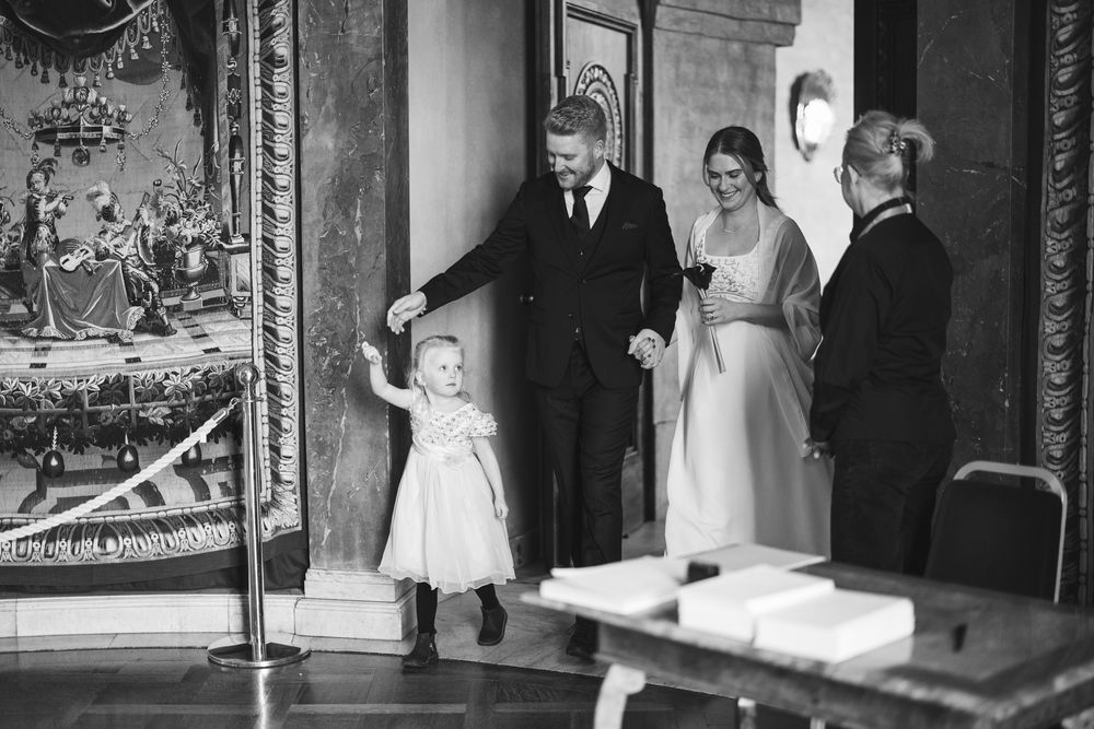 A collection of black and white wedding photographs arranged in a horizontal strip showing various ceremony moments.