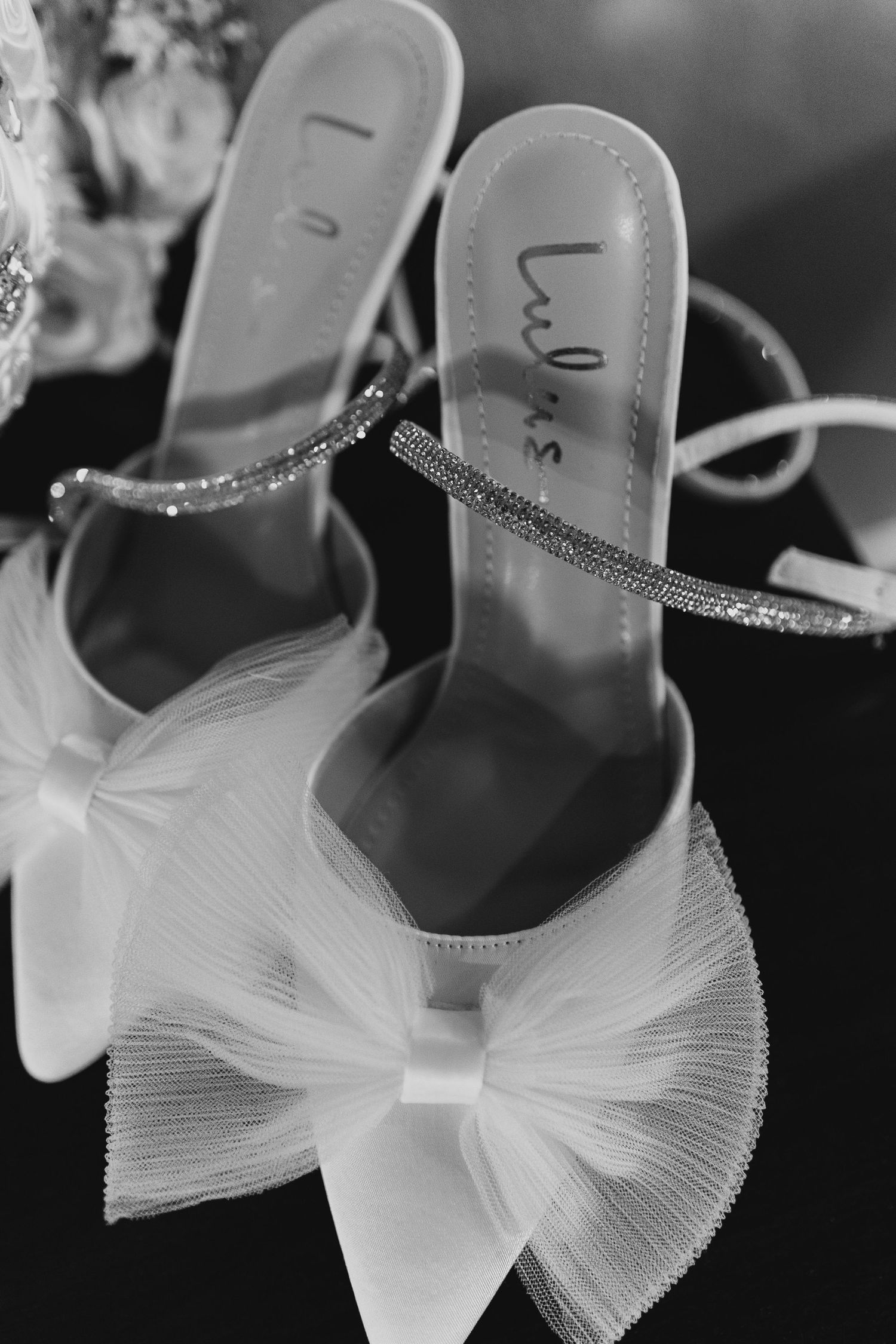 Close-up black and white photo series showing delicate white tulle bows on elegant bridal shoes.