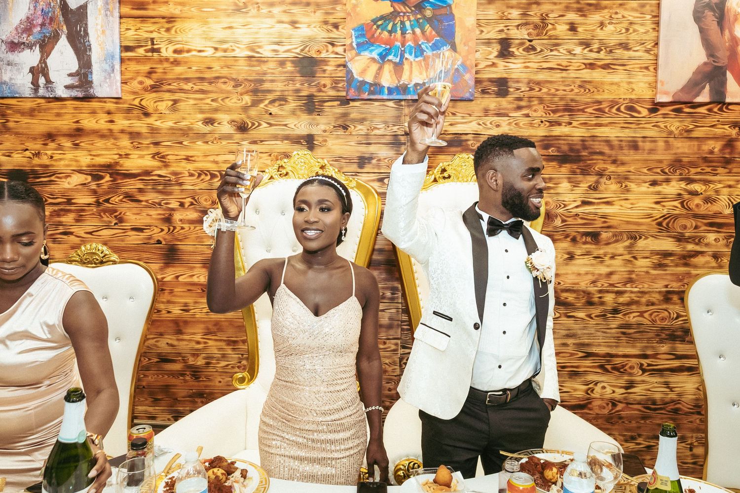 People dancing and celebrating at a rustic venue with exposed brick walls during a lively party or reception.