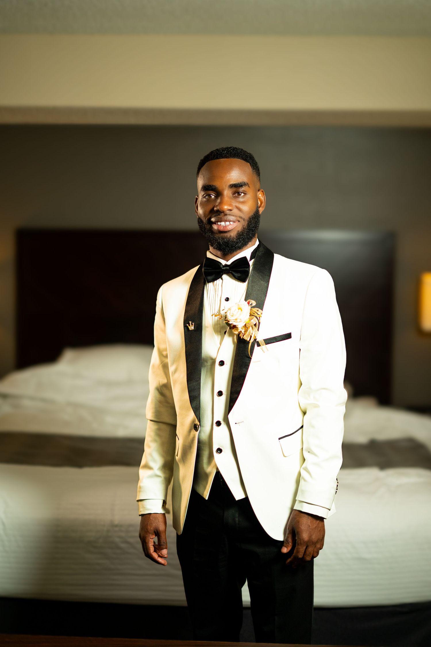 A series of formal portraits showing a groom in a white tuxedo jacket and black bow tie in an elegant setting.