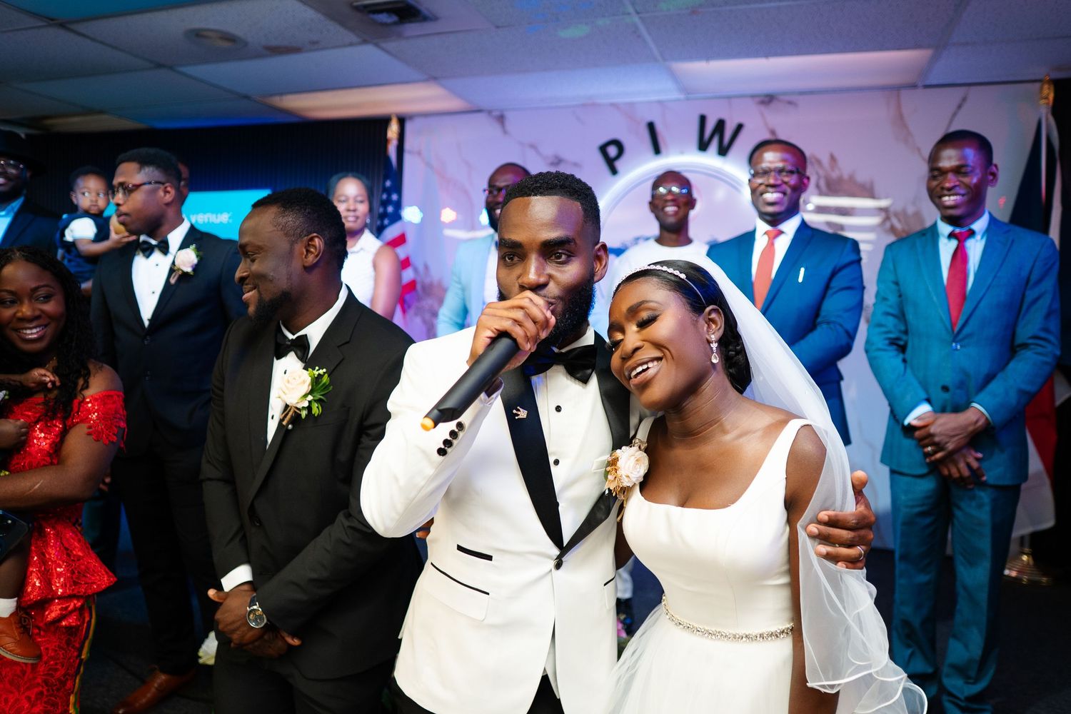 Wedding celebration in a blue-lit reception venue with performers entertaining guests.
