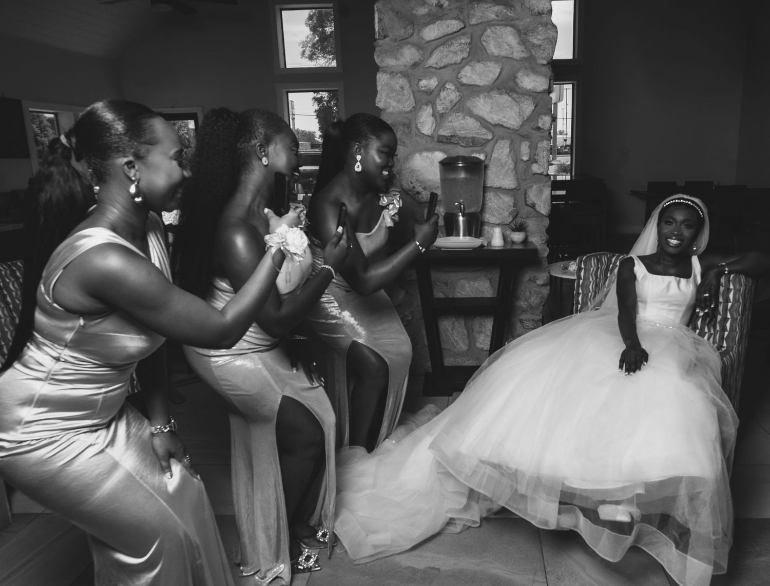 Black and white photos capturing intimate dance moments at a wedding reception with stone wall backdrop.