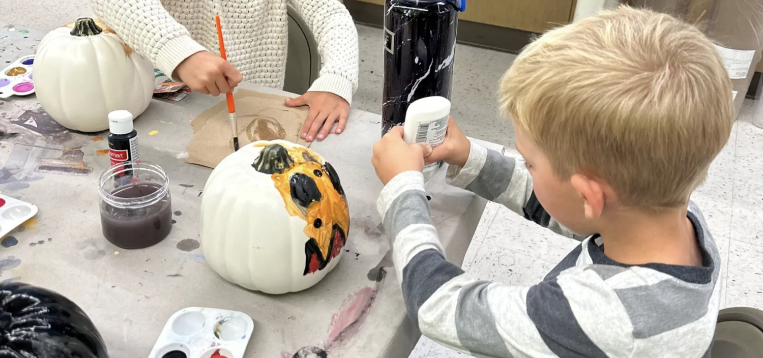 Children painting pumpkins at a Micheals Makebreak in Littleton, CO
