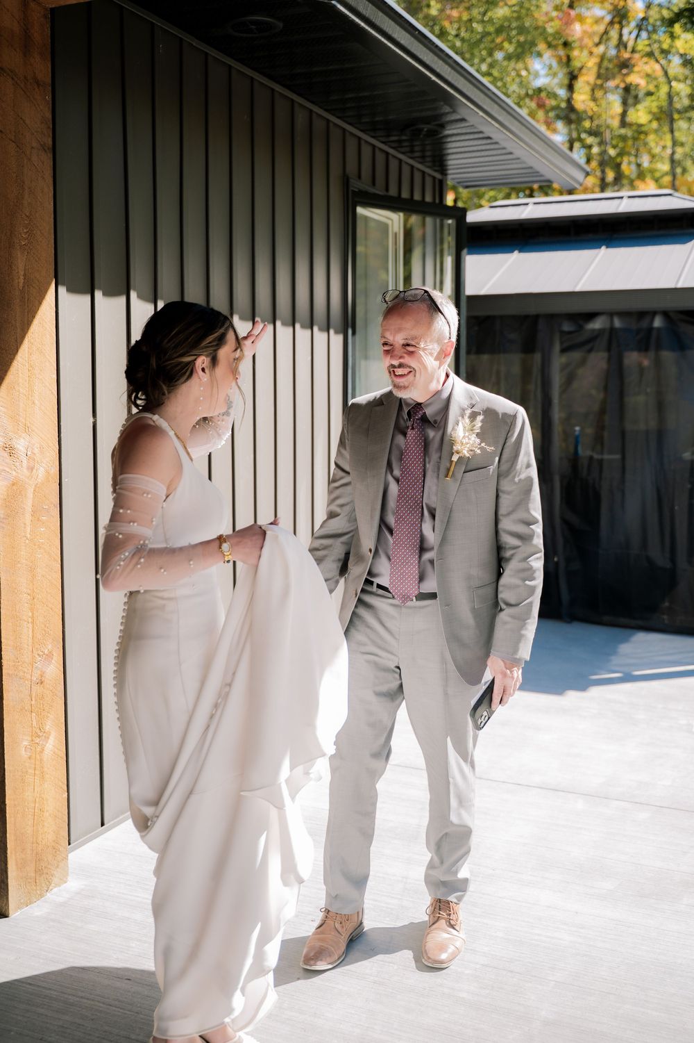 Three sequential photos show a tender first look moment between a bride in white and groom in gray at an outdoor venue.