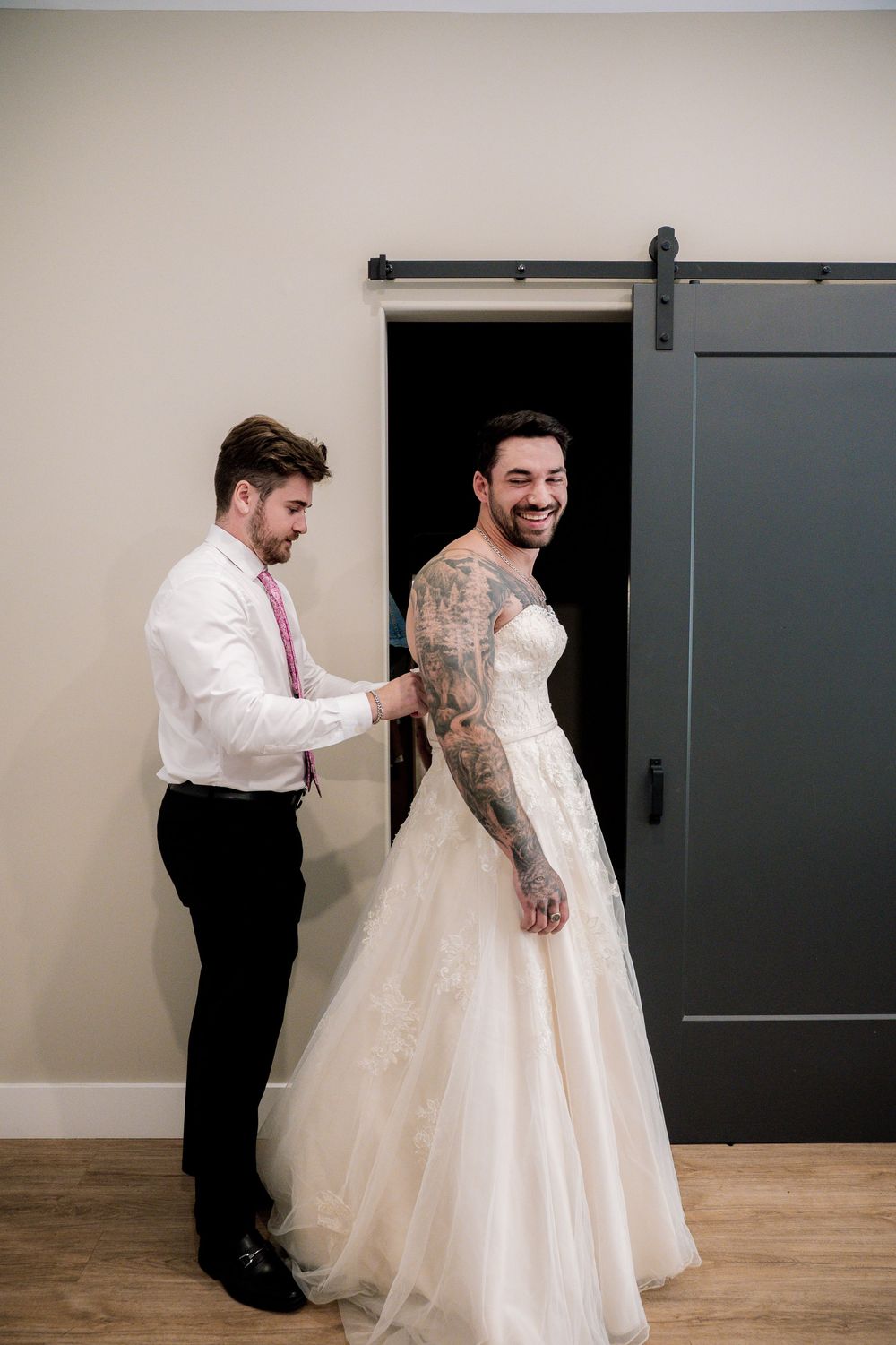 A sequence of photos showing someone helping to adjust a white wedding dress against a minimalist indoor backdrop.
