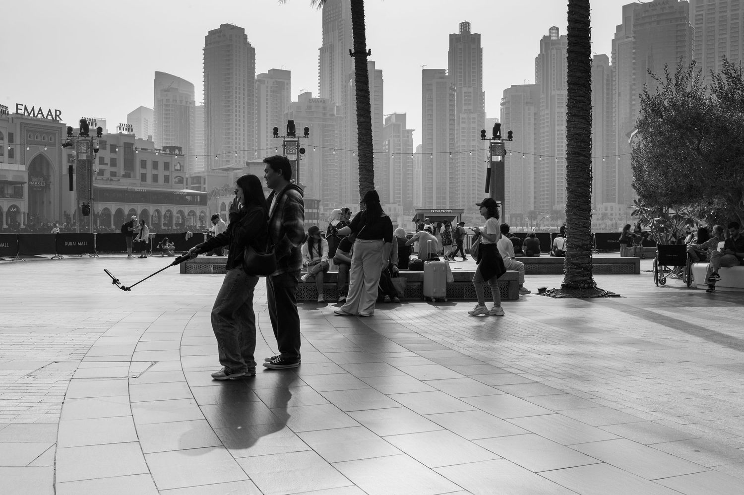 A series of black and white urban street photographs showing people walking through city spaces and architectural elements.