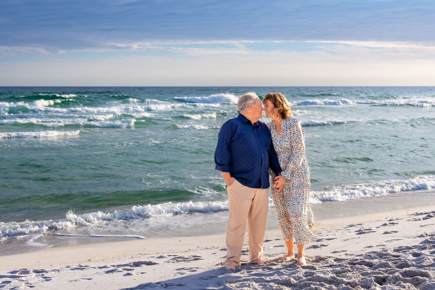 A series of romantic beach photos showing a couple walking together along the shoreline at sunset.
