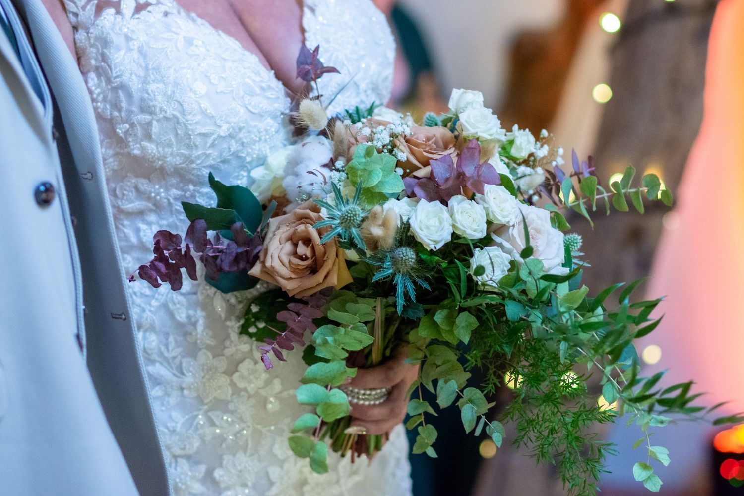 Autumn wedding flowers at The Plough Inn, Eaton: A bride holding a seasonal bouquet during a barn ceremony, captured by Michael Pardoe