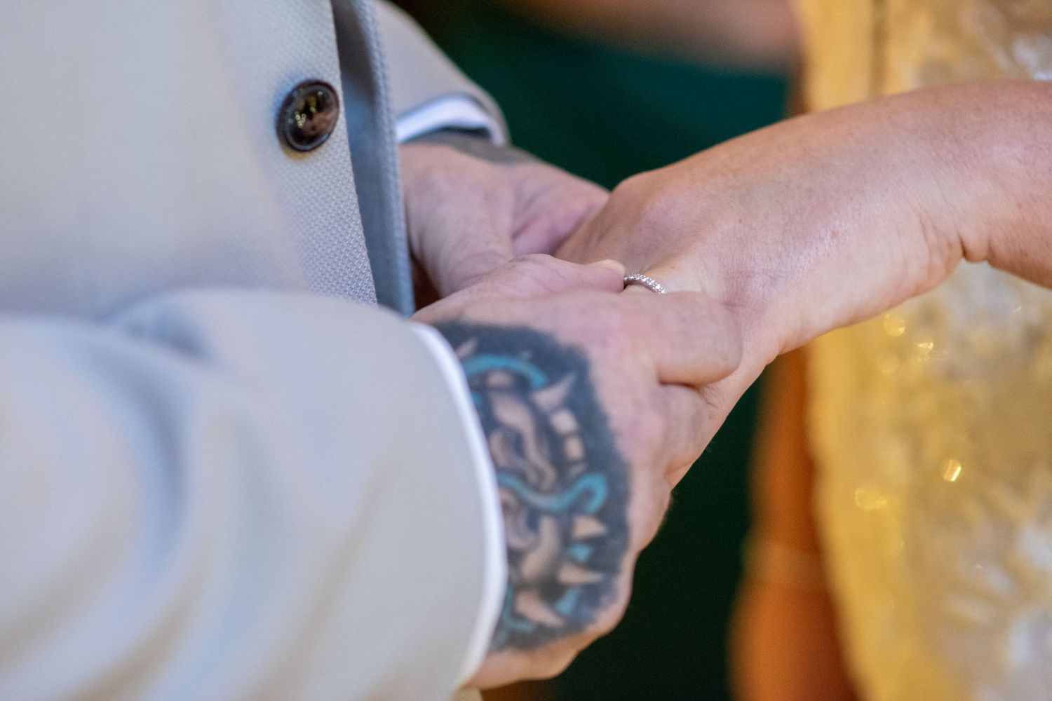 Groom placing a wedding ring on the bride's finger at The Plough Inn, Eaton; captured by Runcorn wedding photographer Michael Pardoe.
