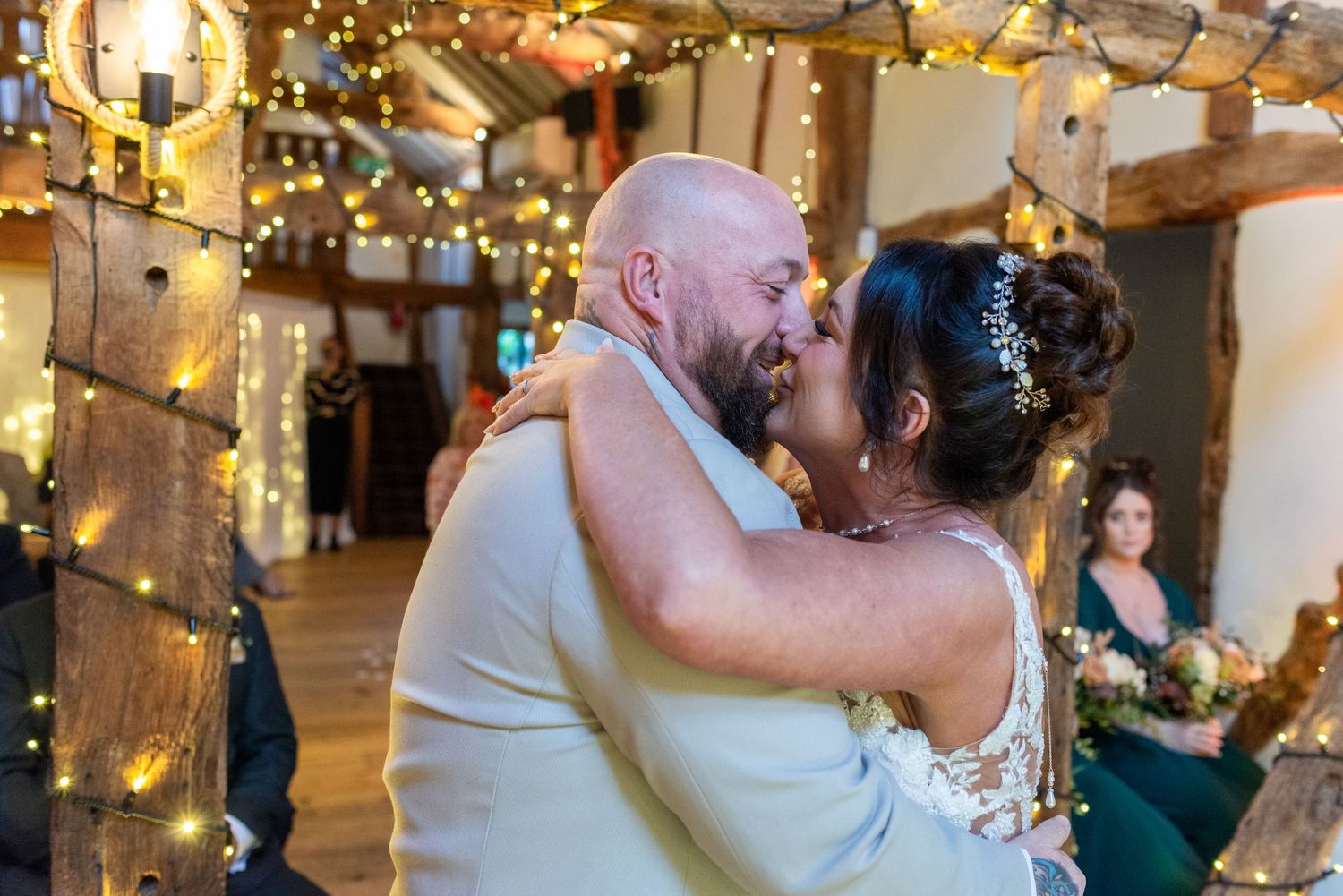 Bride and groom’s first kiss during a barn wedding ceremony at The Plough Inn, Eaton; Cheshire wedding photography by Michael Pardoe