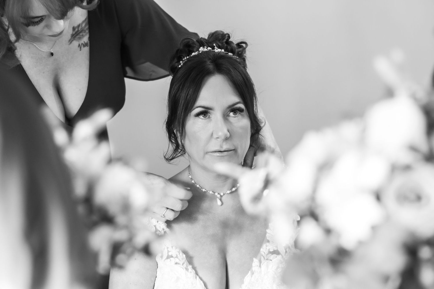 Candid black and white bridal preparation at The Plough Inn, Eaton; documentary wedding photography in Cheshire by Michael Pardoe